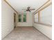 An empty sunroom features a ceiling fan, multiple windows, and tile flooring at 1530 21St N Ave, St Petersburg, FL 33704