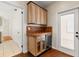 Elegant wet bar area with wooden cabinets, tile backsplash, wine cooler, and access to the exterior at 1530 21St N Ave, St Petersburg, FL 33704