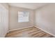 This bedroom features wood floors, neutral paint and trim, closet and window at 15801 Cottontail Pl, Tampa, FL 33624