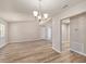 Bright dining room featuring wood-look floors, neutral walls, and a chandelier light fixture at 15801 Cottontail Pl, Tampa, FL 33624