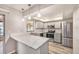 Updated kitchen with stainless steel appliances, granite countertops, stylish backsplash, and modern lighting fixtures at 15801 Cottontail Pl, Tampa, FL 33624