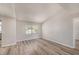 Spacious living room features wood-look flooring, neutral paint and a large window to bring in plenty of natural light at 15801 Cottontail Pl, Tampa, FL 33624