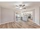 Open living space featuring wood-look floors and access to kitchen, and an outdoor patio at 15801 Cottontail Pl, Tampa, FL 33624