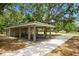 Picnic area featuring covered tables, concrete flooring, and an expansive shaded area at 15801 Cottontail Pl, Tampa, FL 33624