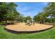 Outdoor playground featuring various play structures, a slide, and a wood chip ground cover at 15801 Cottontail Pl, Tampa, FL 33624