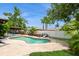 Backyard pool featuring a spacious patio, lounge chairs, lush landscaping, and privacy fence at 15801 Cottontail Pl, Tampa, FL 33624