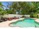Backyard pool featuring a spacious patio with seating and lush landscaping, perfect for relaxation at 15801 Cottontail Pl, Tampa, FL 33624