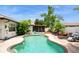 Inviting backyard pool is surrounded by mature trees and landscaping, with furniture at 15801 Cottontail Pl, Tampa, FL 33624