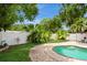 Secluded pool area surrounded by a privacy fence, mature trees, and lush landscaping at 15801 Cottontail Pl, Tampa, FL 33624