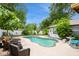 Inviting backyard pool is surrounded by mature trees and landscaping at 15801 Cottontail Pl, Tampa, FL 33624