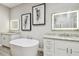 This luxurious bathroom features dual sinks, granite countertops, and a free-standing soaking tub at 17 Franklin S Ct # C, St Petersburg, FL 33711