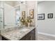 Lovely bathroom with granite counters, stylish vanity, and a modern faucet, adjacent to the living room at 17 Franklin S Ct # C, St Petersburg, FL 33711