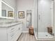 Beautiful bathroom featuring a walk-in shower, granite countertops, white cabinetry, and stylish fixtures at 17 Franklin S Ct # C, St Petersburg, FL 33711