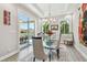 Elegant dining room with a modern chandelier and sliding glass doors to the outdoor patio at 17 Franklin S Ct # C, St Petersburg, FL 33711