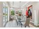 Bright dining room with a modern glass table, seating for six, and sliding door access to the patio at 17 Franklin S Ct # C, St Petersburg, FL 33711