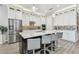 Stylish kitchen featuring a large island with barstool seating, stainless steel appliances, and ample cabinet space at 17 Franklin S Ct # C, St Petersburg, FL 33711