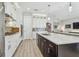 Contemporary kitchen with a large island, stainless steel appliances, modern cabinetry, and a seamless flow to the living area at 17 Franklin S Ct # C, St Petersburg, FL 33711