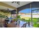 Spacious lanai with dining, lounge areas, and a serene lake view for relaxing outdoor living at 17 Franklin S Ct # C, St Petersburg, FL 33711
