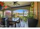 Relaxing lanai featuring a dining table, potted plants, and a scenic lake view at 17 Franklin S Ct # C, St Petersburg, FL 33711