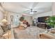 Spacious living room with ceiling fan, neutral carpeting, and entertainment center, offering a cozy and inviting atmosphere at 17 Franklin S Ct # C, St Petersburg, FL 33711