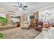 Open living room with neutral carpeting, and a view into the bedroom offering a versatile layout for comfortable living at 17 Franklin S Ct # C, St Petersburg, FL 33711