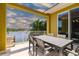 Outdoor patio featuring a dining table and seating overlooking the scenic lake at 17 Franklin S Ct # C, St Petersburg, FL 33711