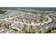 Aerial view showcasing a serene pond nearby numerous single-Gathering homes at 18827 Henequen Lane, Spring Hill, FL 34610