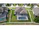 Aerial view of backyard featuring a screened pool, lush lawn, and privacy fence at 18827 Henequen Lane, Spring Hill, FL 34610