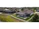 Aerial view of a backyard with a screened pool, privacy fence, and green grass in a desirable neighborhood at 18827 Henequen Lane, Spring Hill, FL 34610