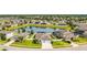 Scenic aerial view of a residential community, highlighting the pond, lush greenery, and well-maintained homes at 18827 Henequen Lane, Spring Hill, FL 34610