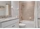 Bathroom featuring a granite vanity top, white cabinets, shower with tile surround and a matching shower curtain at 18827 Henequen Lane, Spring Hill, FL 34610