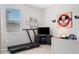 room with decor, including a Mickey Mouse theme, a mounted TV, and a treadmill for exercise at 18827 Henequen Lane, Spring Hill, FL 34610