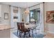 Cozy dining area featuring stylish chandelier lighting and a view of the screened outdoor space at 18827 Henequen Lane, Spring Hill, FL 34610