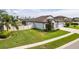 Beautiful single-Gathering home with a well-manicured lawn, a side-entry garage, and neutral colored exterior at 18827 Henequen Lane, Spring Hill, FL 34610
