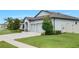 Lovely single-Gathering home with a three car garage, a concrete driveway, and a well-kept lawn at 18827 Henequen Lane, Spring Hill, FL 34610