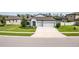 Charming single-story home with a well-maintained lawn and spacious driveway leading to a two-car garage at 18827 Henequen Lane, Spring Hill, FL 34610