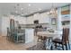 Open concept kitchen with modern appliances, granite countertops, stylish pendant lights, and a cozy dining area at 18827 Henequen Lane, Spring Hill, FL 34610