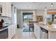 Open concept kitchen and dining area showcasing modern appliances, granite countertops and lots of natural light at 18827 Henequen Lane, Spring Hill, FL 34610
