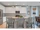 Bright kitchen features a granite countertop island with modern appliances and stylish pendant lighting at 18827 Henequen Lane, Spring Hill, FL 34610