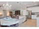 Open kitchen design with stainless steel appliances and granite countertops, leading into a dining area at 18827 Henequen Lane, Spring Hill, FL 34610