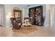 Cozy living area featuring decorative bookshelves, comfortable armchairs, and a stylish coffee table on a textured rug at 18827 Henequen Lane, Spring Hill, FL 34610