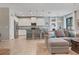 Open floor plan showcasing a kitchen with a breakfast bar flowing into a comfortable living area with a sectional sofa at 18827 Henequen Lane, Spring Hill, FL 34610