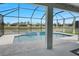 Spacious screened in pool area with brick pavers, water feature, and views of the surrounding neighborhood at 18827 Henequen Lane, Spring Hill, FL 34610
