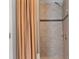 Shower boasts contemporary tile work with a decorative accent stripe and modern fixtures at 18827 Henequen Lane, Spring Hill, FL 34610