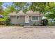 Charming single-story home featuring a simple front facade with grey paint, complemented by the surrounding lush greenery at 2038 16Th S St, St Petersburg, FL 33705