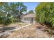 Cozy one-story home showcasing mature trees, and a lattice-enclosed porch at 2038 16Th S St, St Petersburg, FL 33705