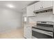 Bright kitchen features white cabinets, tile backsplash and modern oven range at 2038 16Th S St, St Petersburg, FL 33705