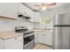 Bright kitchen with white cabinets, stainless steel refrigerator and stove, offering a functional and clean space at 2038 16Th S St, St Petersburg, FL 33705