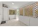 Enclosed sunroom with lattice walls and windows, ceiling fan, and tile flooring at 2038 16Th S St, St Petersburg, FL 33705