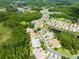 A community with homes and manicured lawns is highlighted, alongside lush green spaces and a tranquil pond at 21209 Diamonte Dr, Land O Lakes, FL 34637